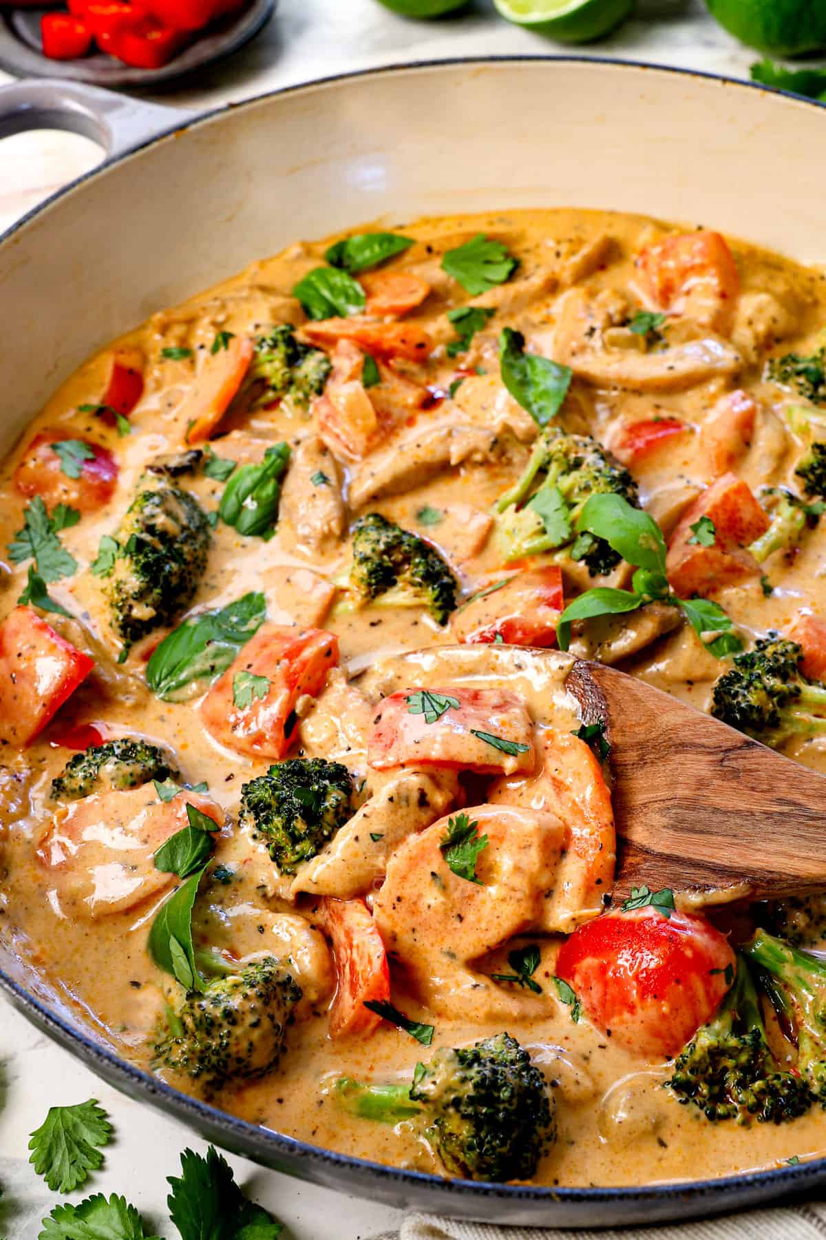 spooning Thai curry recipe showing the chicken, veggies, and creamy texture