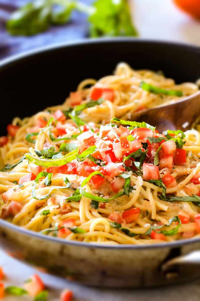 Close up of a pan of Garlic Mozzarella Margherita Pasta with basil.