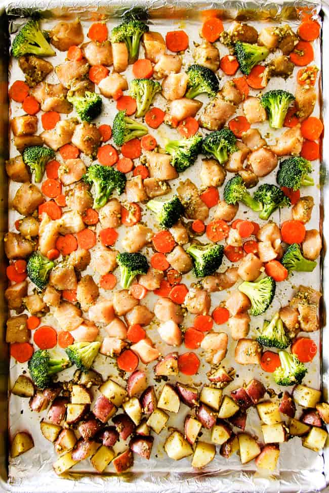Showing how to make Sheet Pan Parmesan Pesto Chicken with Potatoes, Broccoli and Carrots by baking it on a sheet pan.