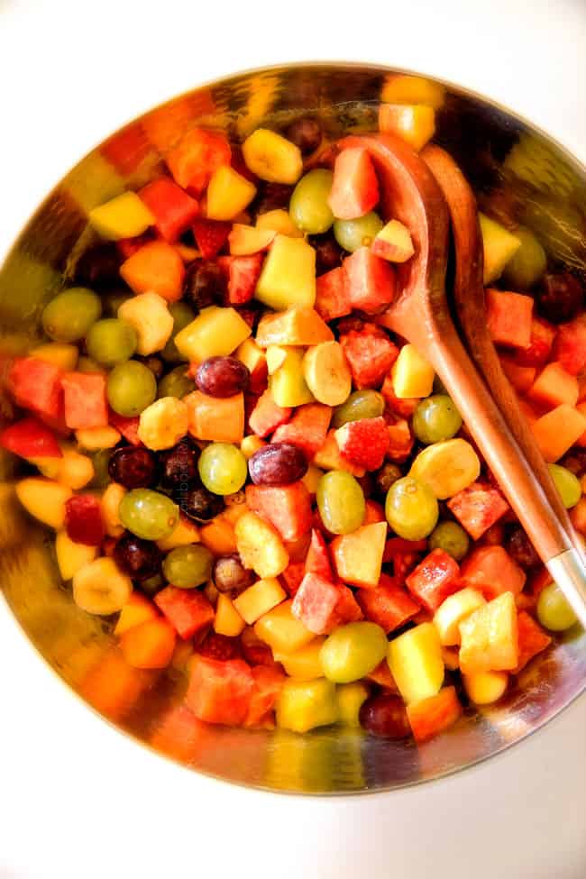Watermelon Salad with Creamy Citrus Glaze - I took this to a barbecue and it was gone in minutes! Its so cool and refreshing withe the BEST GLAZE and I love the combo of melons, strawberries, bananas, apples and grapes! top view of easy watermelon salad in a silver bowl