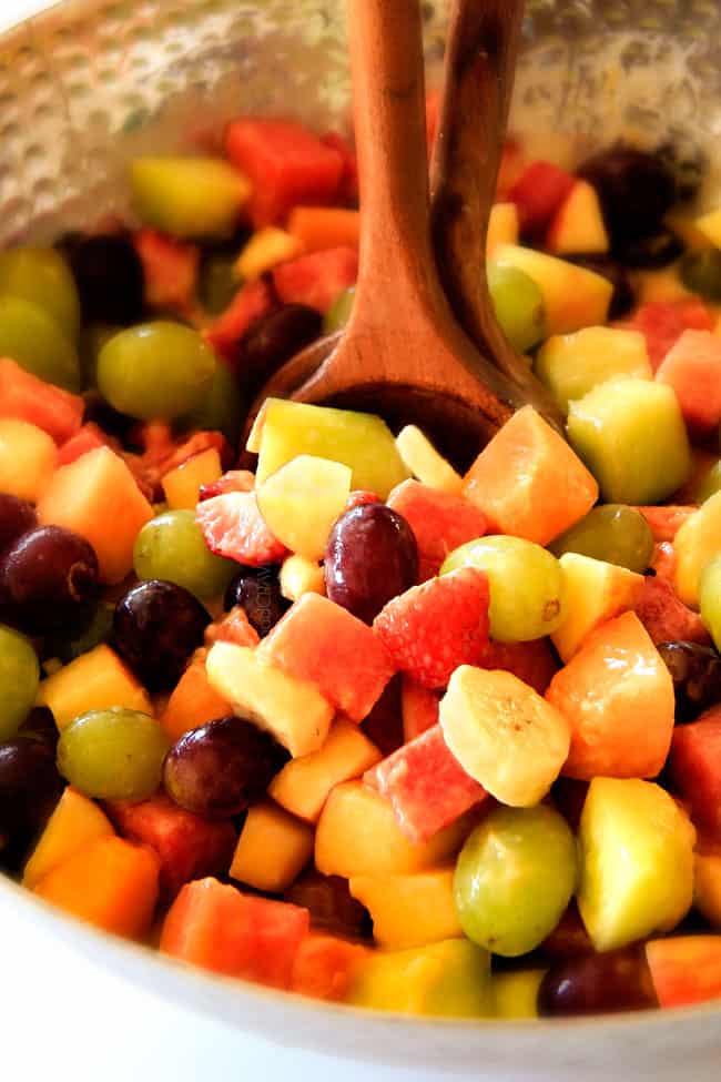 Watermelon Salad with Creamy Citrus Glaze - I took this to a barbecue and it was gone in minutes! Its so cool and refreshing withe the BEST GLAZE and I love the combo of melons, strawberries, bananas, apples and grapes! up close of summer fruit salad with watermelon