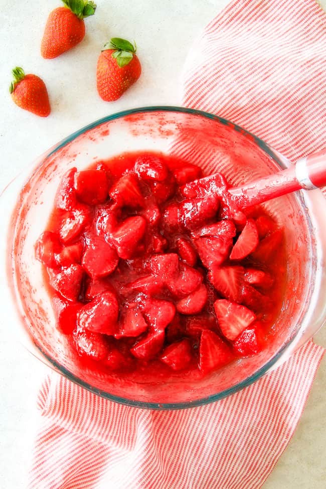 Showing how to make Strawberry Cheesecake by mixing strawberries.