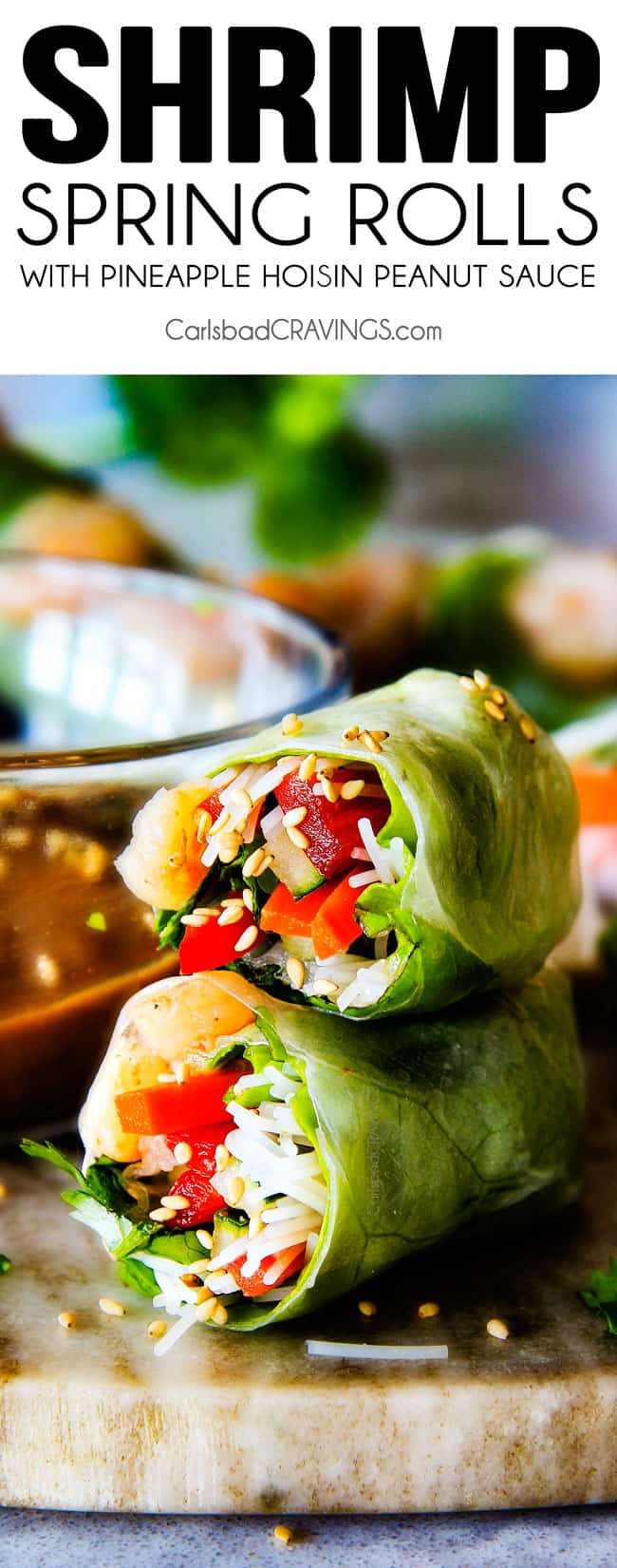 These insanely delicious Fresh Shrimp Spring Rolls are a flavor and texture explosion in every addictive bite and super easy to make with all my tips and tricks and step by step photos! and the the Pineapple Hoisin Peanut Sauce is EVERYTHING! Vietnamese Spring Rolls cut in half and stacked on top of each other on a cutting board