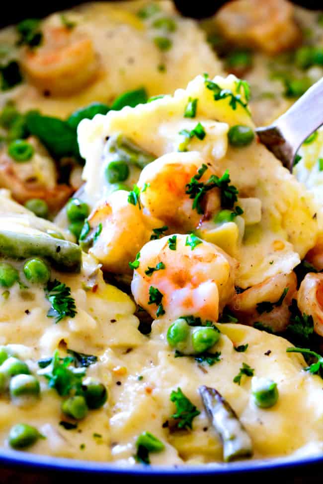 Close up of One Pot Lemon Garlic Cream Ravioli with Shrimp and Asparagus and peas.