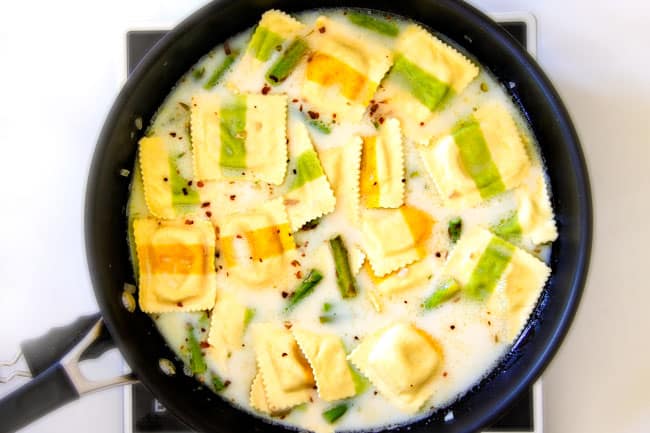 Showing how to make One Pot Lemon Garlic Cream Ravioli with Shrimp and Asparagus .
