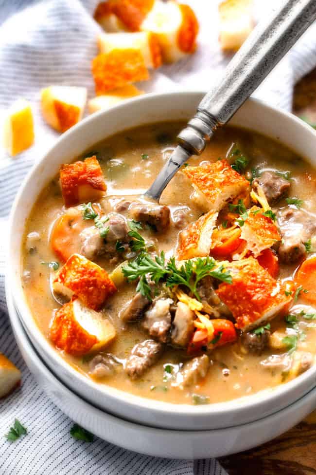 Top view of Philly Cheesesteak Soup in a white bowl.