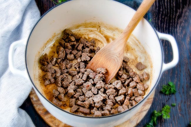 Showing how to make Philly Cheesesteak Soup cooking steak in a pot.