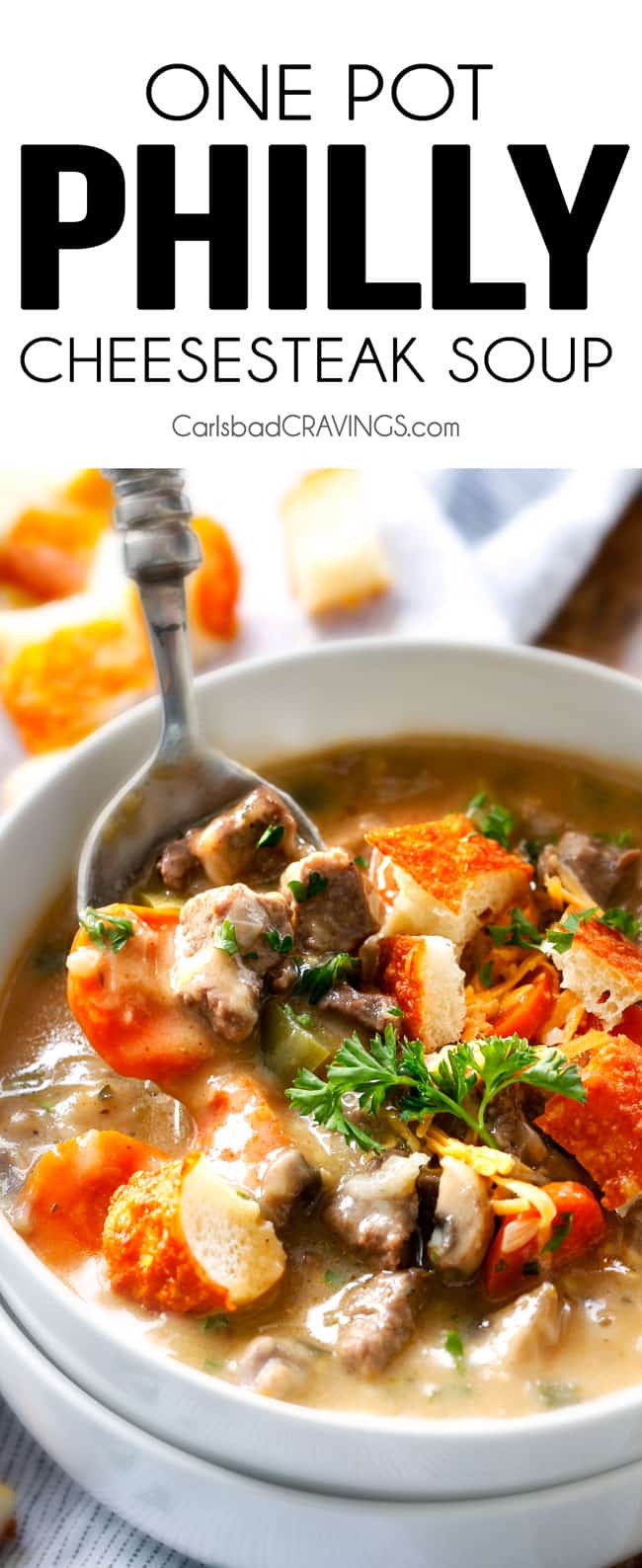 Philly Cheesesteak Soup with a spoon and parsley garnish. 