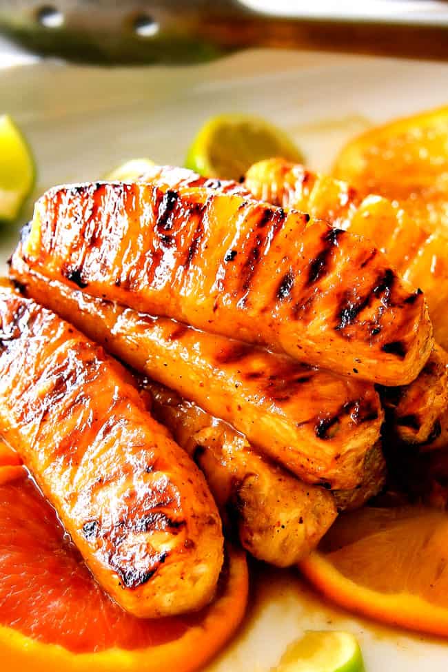 the BEST Caramelized Grilled Pineapple smothered with the moist irresistible buttery, sweet, tangy Brown Sugar Orange Glaze! You will never want to eat pineapple any other way again! Serve it as an easy appetizer, side or even dessert all summer long! healthy grilled pineapple stacked together with dark grill marks
