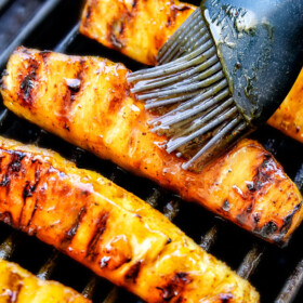 the BEST Caramelized Grilled Pineapple glazed with the moist irresistible buttery, tangy Brown Sugar Chili Glaze! You will never want to eat pineapple any other way again! Serve it as an easy appetizer, side or even dessert all summer long!