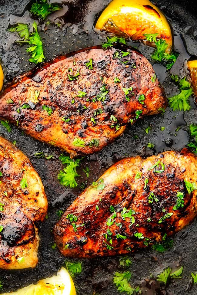 showing how to cook marinated Greek Chicken on the stove in a pan