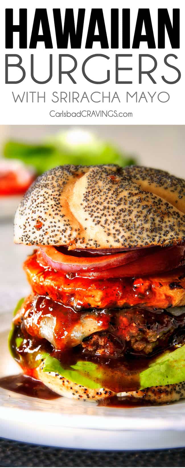 Amazingly juicy Hawaiian Burgers BURSTING with flavor, smothered in Havarti cheese, more Hawaiian Sauce and topped with caramelized pineapple. This might be the best burger. EVER! up close of a juicy Hawaiian Burger on a plate with pineapple, cheese, lettuce, red onions and tomato