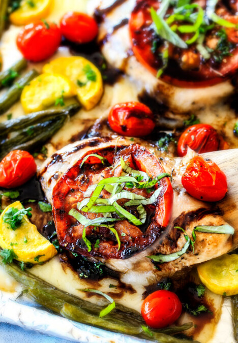 Sheet Pan Caprese Balsamic Chicken and Veggies - an easy, satisfying meal all in one! Wonderfully juicy, flavor bursting chicken smothered in gooey mozzarella cheese with fresh basil and the most incredible balsamic reduction!