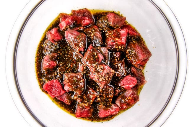 Showing how to make Brazilian Steak Kabobs by marinading steak.