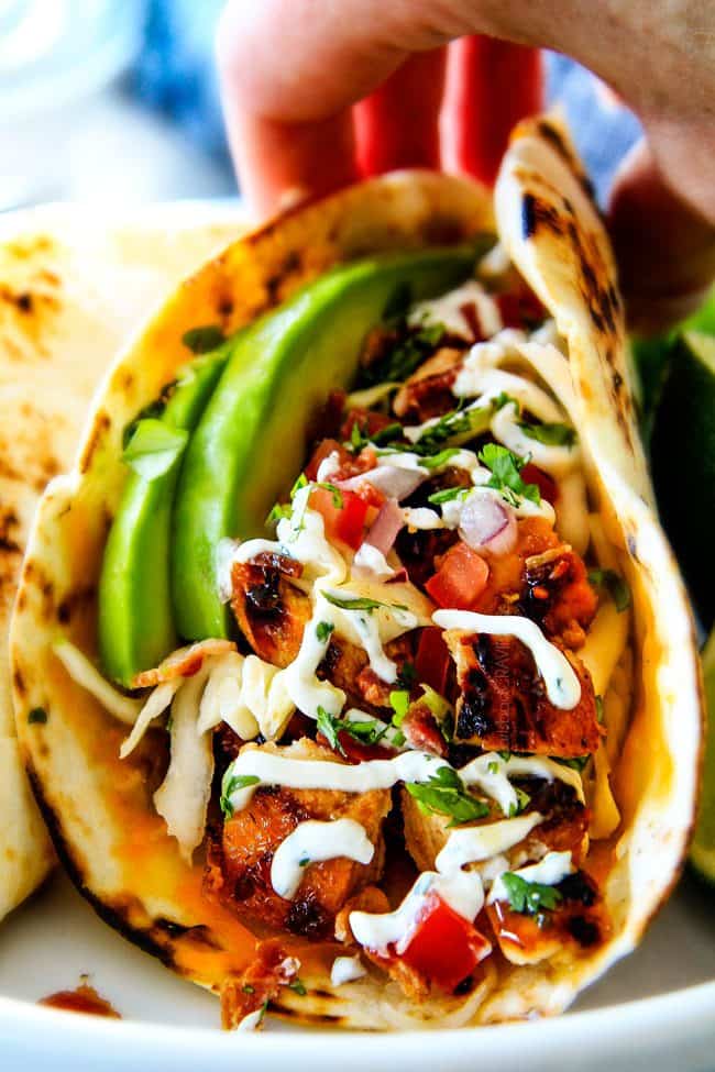 These are ADDICTINGLY DELICIOUS! ย Honey Chipotle Chicken Tacosย stuffed with wonderfully juicy, flavor packed Honey Chipotle Bacon Chicken (yes BACON chicken!), piled with crispy BLT Slaw and creamified with Cilantro Lime Crema! ย