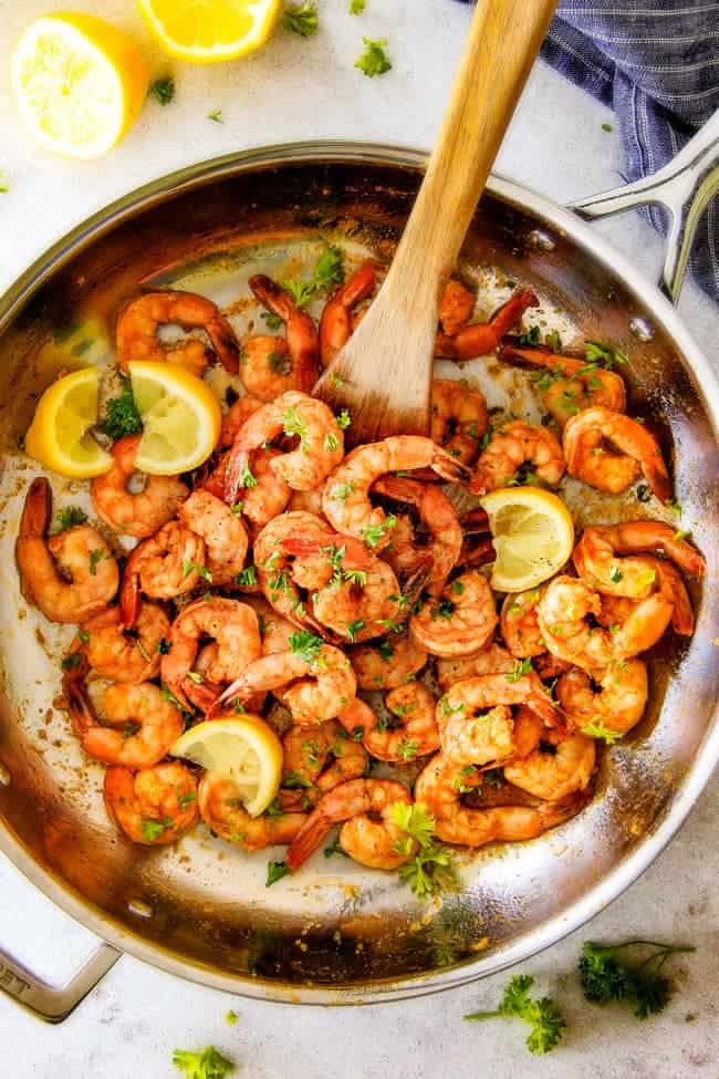 quick and easy Old Bay Shrimp (Grill or Stove top) is so juicy and flavorful and the homemade Cocktail Sauce is amazing! ย Serve it as an appetizer or add some sides and call it dinner!ย top view of easy Old Bay Shrimp in a large stainless steel skillet
