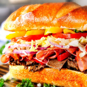 Easy, customizable LOADED Slow Cooker Italian Beef Sandwiches are crazy tender, seeping with flavor and unbelievably delicious! They make the easiest dinner or party food and super fun (make ahead!) sandwich bar! ย