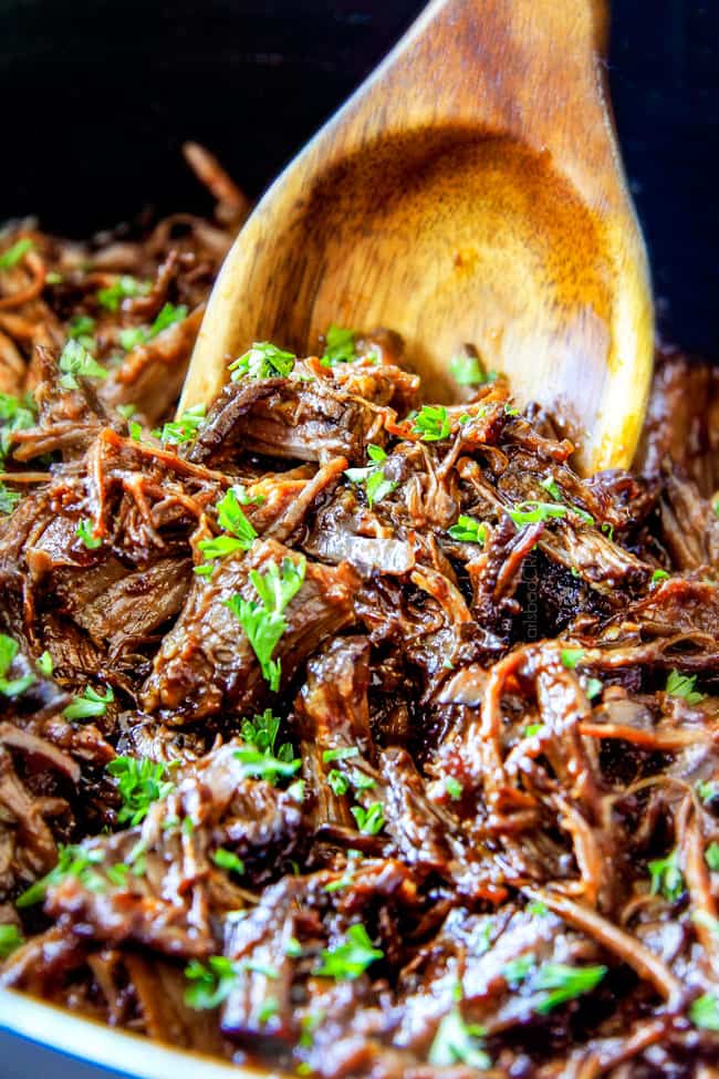 I am obsessed with this sweet and tangy, savory Slow Cooker Honey Balsamic Beef!!! ย It's fall apart tender, crazy juicy, packed with flavor and smothered in the most AMAZING honey balsamic sauce! ย perfect for sandwiches or stand alone delicious with rice and potatoes! up close of slow cooker roast beef for sandwiches