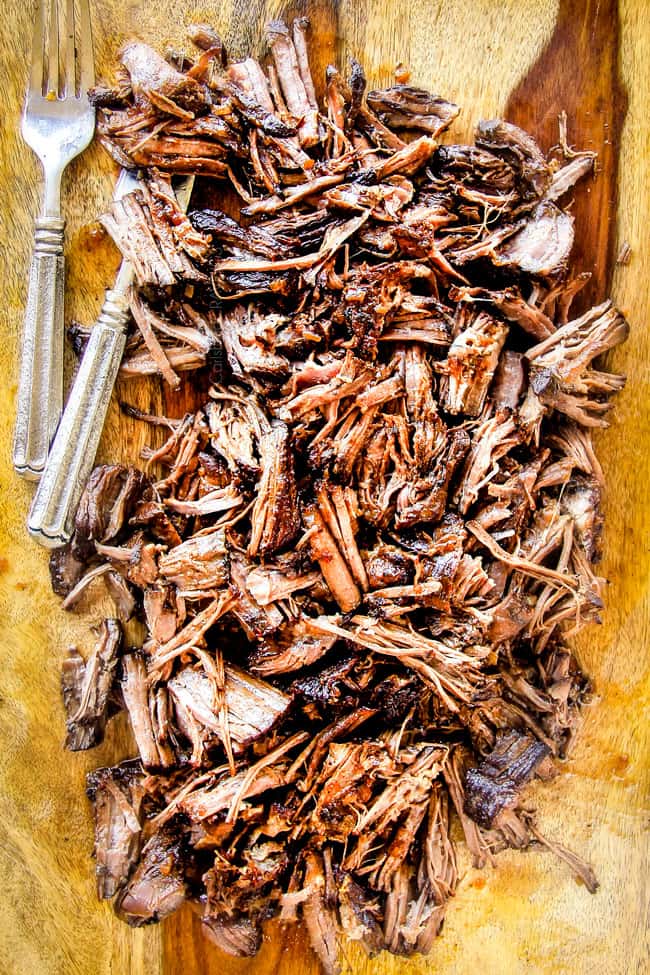 I am obsessed with this sweet and tangy, savory Slow Cooker Honey Balsamic Beef!!! ย It's fall apart tender, crazy juicy, packed with flavor and smothered in the most AMAZING honey balsamic sauce! ย perfect for sandwiches or stand alone delicious with rice and potatoes! showing how to make slow cooker roast beef by shredding tender chuck roast