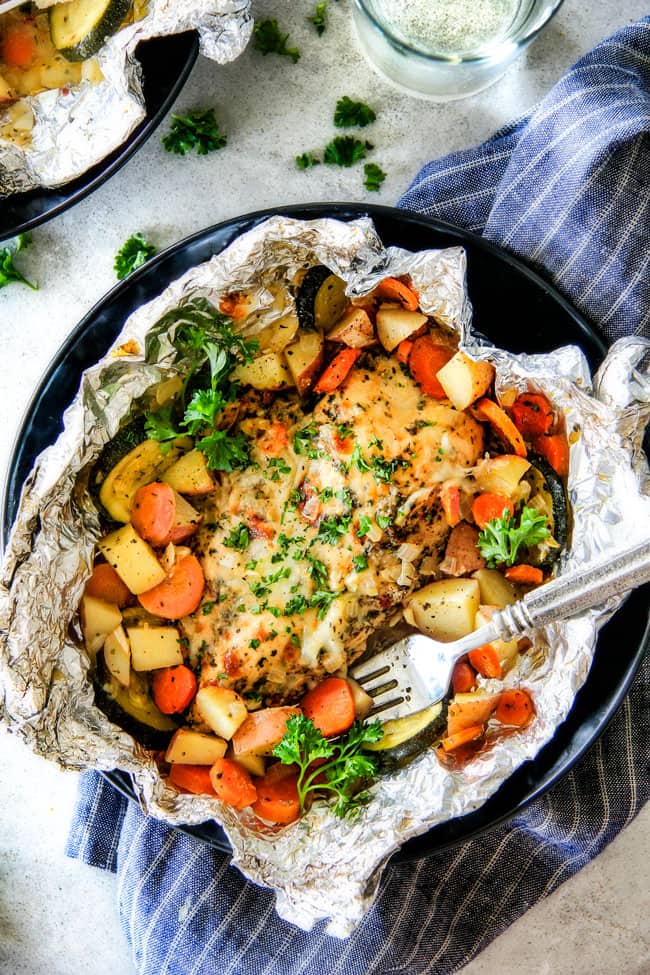Baked or Grilledย Italian Mozzarella Chicken Foil Packets are bursting with astonishingly juicy, flavorful chicken and tender, seasoned Potatoes, Carrots and Zucchini all smothered with Mozzarella Cheese! ย These foil packets are meal-in-one that are quick to throw together and even quicker to clean up!ย