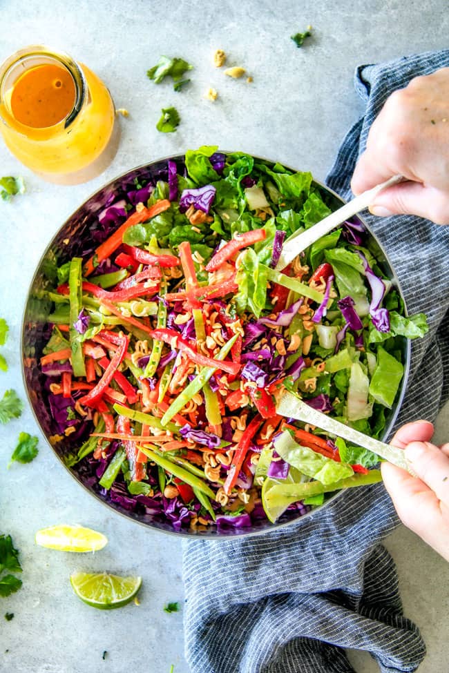 Serving Crunchy Asian Salad with Sriracha Peanut Dressing.