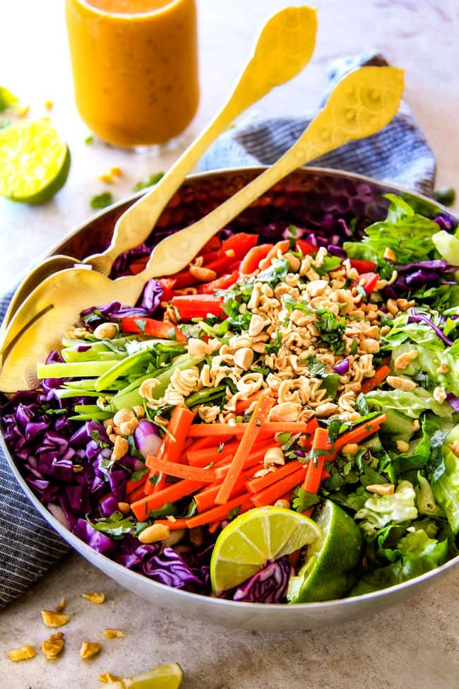 Crunchy Asian Salad with Sriracha Peanut Dressing with limes.