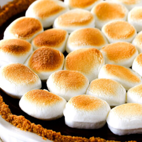 Make ahead Almost No Bake Nutella S'mores Pie is decadantly rich and creamy topped with golden marshmallows and SO EASY! ย I made this for a dinner party and everyone wanted the recipe!ย