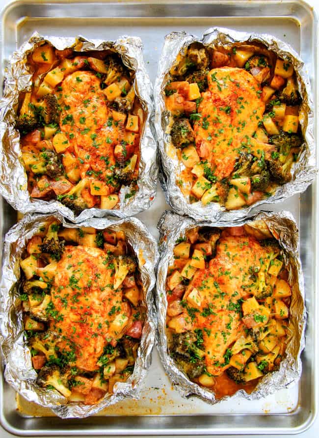 EASY Baked or Grilled Cheesy Buffalo Chicken Foil Packets bursting with juicy chicken and tender, flavorful veggies all smothered in cheddar and dipped in Ranch Crema! ย these are SO addictingly delicious!!! ย ย