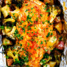 EASY Baked or Grilled Cheesy Buffalo Chicken Foil Packets bursting with juicy chicken and tender, flavorful veggies all smothered in cheddar and dipped in Ranch Crema! ย these are SO addictingly delicious!!! ย ย