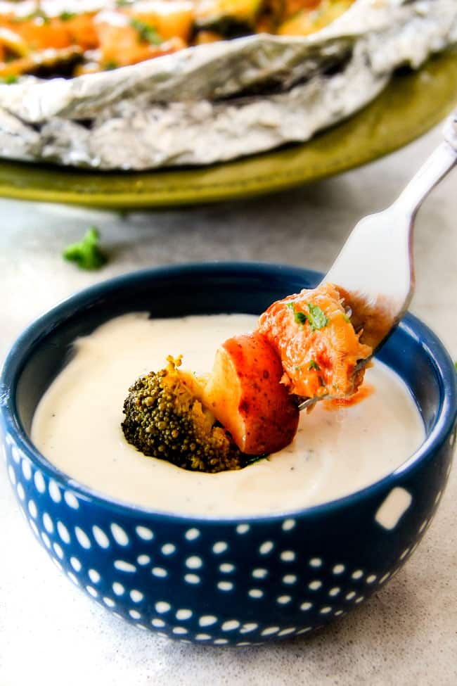 EASY Baked or Grilled Cheesy Buffalo Chicken Foil Packets bursting with juicy chicken and tender, flavorful veggies all smothered in cheddar and dipped in Ranch Crema! ย these are SO addictingly delicious!!! ย ย