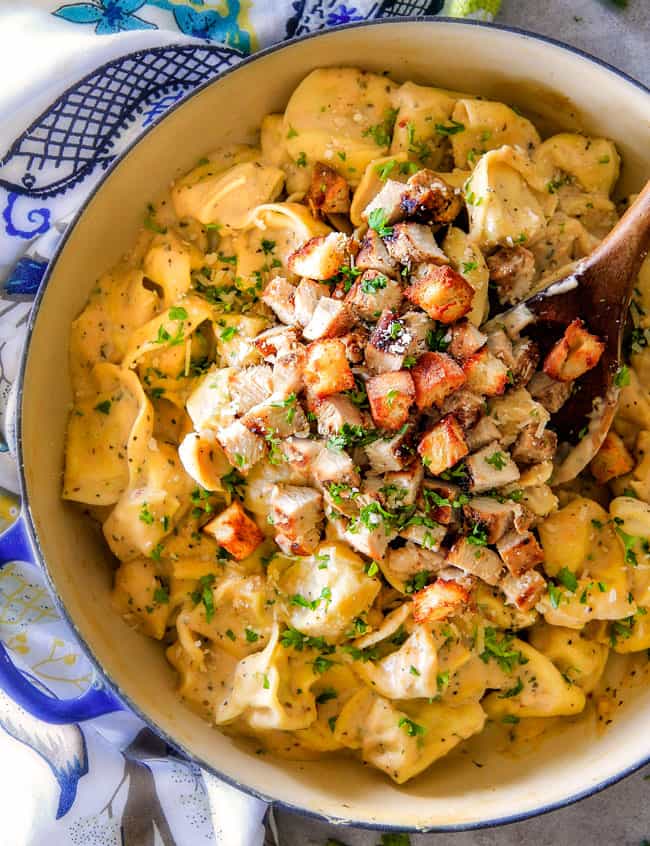 Caesar Chicken Tortellini in a blue and white cast iron pot.