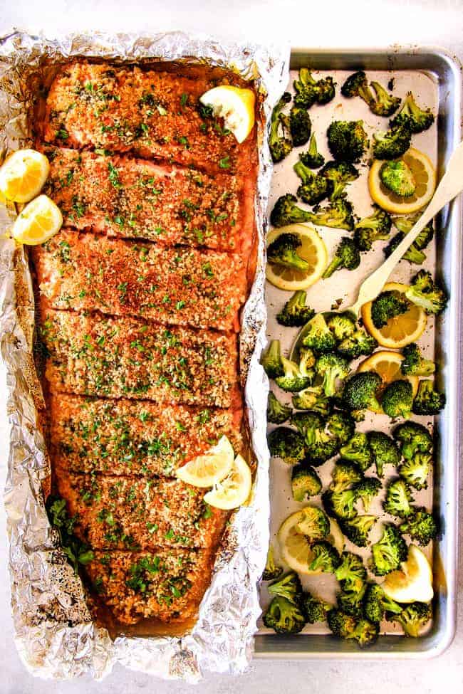 25 MINUTE Baked Lemon Garlic Butter Salmon with Crispy Parmesan Panko & Broccoli!ย This salmon is not only bursting with flavor and sooo juicy and tender but the easiest, most satisfying meal that tastes totally gourmet!ย My parents were blown away by this meal! far away top view of oven baked salmon with broccoli