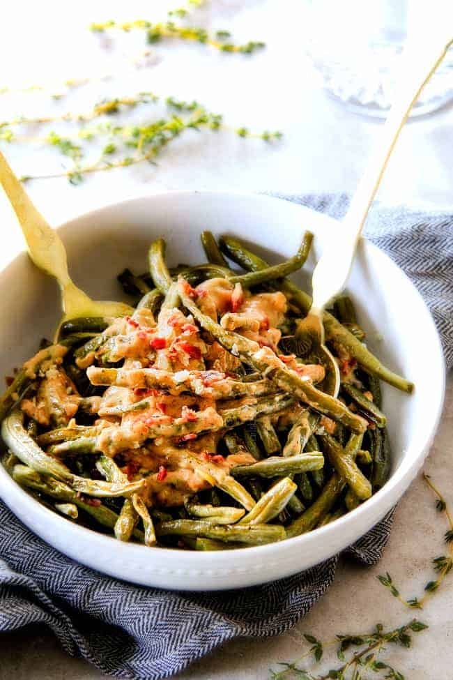 Forget green bean casserole, these wonderfully flavorful, crisp tender Roasted Green Beans with Creamy Gruyere Sauce are AMAZING!!!ย They the best green beans you will ever eat!ย ย They are easy enough for every day but delicious enough for special occasions (like Thanksgiving, Christmas!)!ย ย #greenbeancasserole #thanksgivingrecipe Baked Green Beans in a white bowl