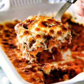 The best everย Sweet Potato Casseroleย with Marshmallows AND buttery, brown sugar Pecan Topping!ย Thisย Sweet Potato Casserole has been our favorite recipe ever since we tasted it almost a decade ago and you will love that you can assemble itย the night before Thanksgiving or Christmas!ย ย No Thanksgiving table is complete without thisย comforting classic!