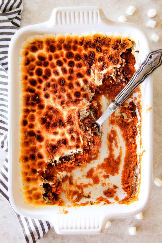 The best everย Sweet Potato Casseroleย with Marshmallows AND buttery, brown sugar Pecan Topping!ย Thisย Sweet Potato Casserole has been our favorite recipe ever since we tasted it almost a decade ago and you will love that you can assemble itย the night before Thanksgiving or Christmas!ย ย No Thanksgiving table is complete without thisย comforting classic!