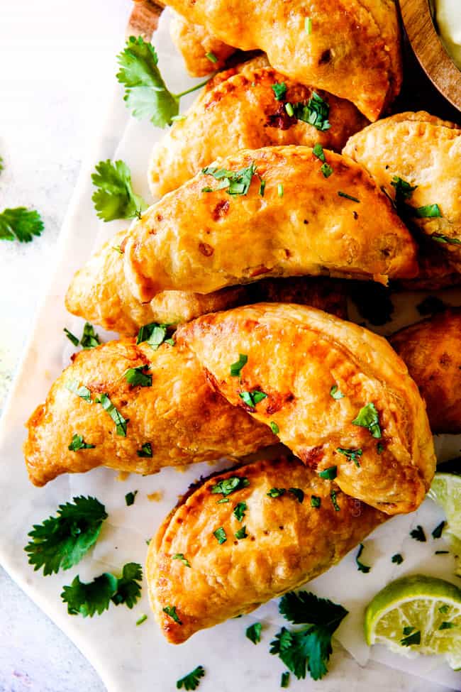 Fresh cooked Chipotle Chicken Empanadas with like on the side.