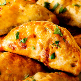 Freezer friendly, juicy, cheesy, shortcut Chipotle Chicken Empanadasย doused in refreshingly Avocado Dipย make the BEST crowd pleasingย appetizers, dinners or snacks and can be made ahead of time and frozen for later!ย The filling is to die for and the store bought puff pastry dough makes an easy shortcut for the buttery, flaky golden pastry!