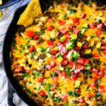 This warm, creamy, cheesy Mexican Spinach Dip is easy, make ahead, bursting with fiestalicious spices and quite possibly the BEST Spinach Dip ever AKA your new back pocket crowd pleasing appetizer for every occasion!