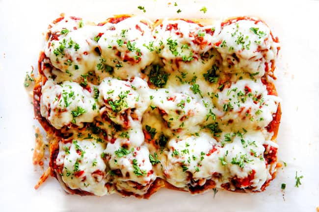 These Cheesy Italian Meatball Sliders are my favorite party food ever and my family loves them for dinner!ย The meatballs are the BEST (so tender and juicy!) and the marinara is amazing and I love how they are individual sliders instead of meatball subs!ย I can't recommend these enough!ย showing how to make meatball sliders by baking sliders until cheese melts