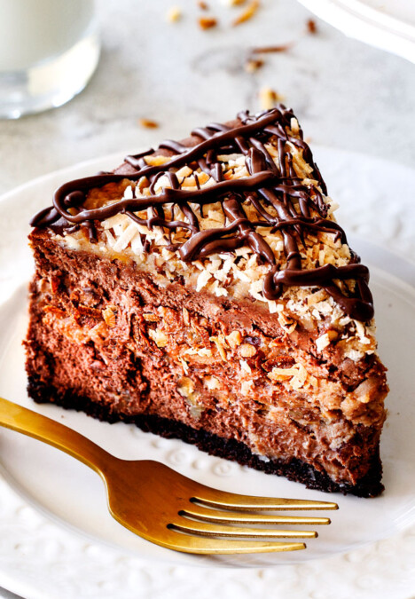German Chocolate Cheesecake AKA the best German Chocolate anything! The rich and creamy chocolate cheesecake has a hidden layer of traditional caramel-eaque sweet and crunchy Coconut Pecan Frosting and another layer on top! This cheesecake is to live for!