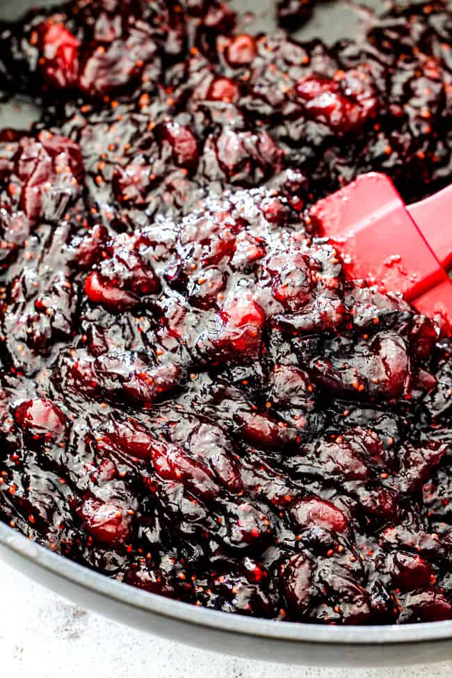 Rich and creamy Baked Brie in Puff Pastry is always a total luxuriously tasting crowd pleaser with minimal effort!ย (step by step pictures included)ย It can be prepped in advance then baked when you're ready for company!ย aaaaaaaaa showing how to make baked brie in puff pastry by simmering pepper jelly jam