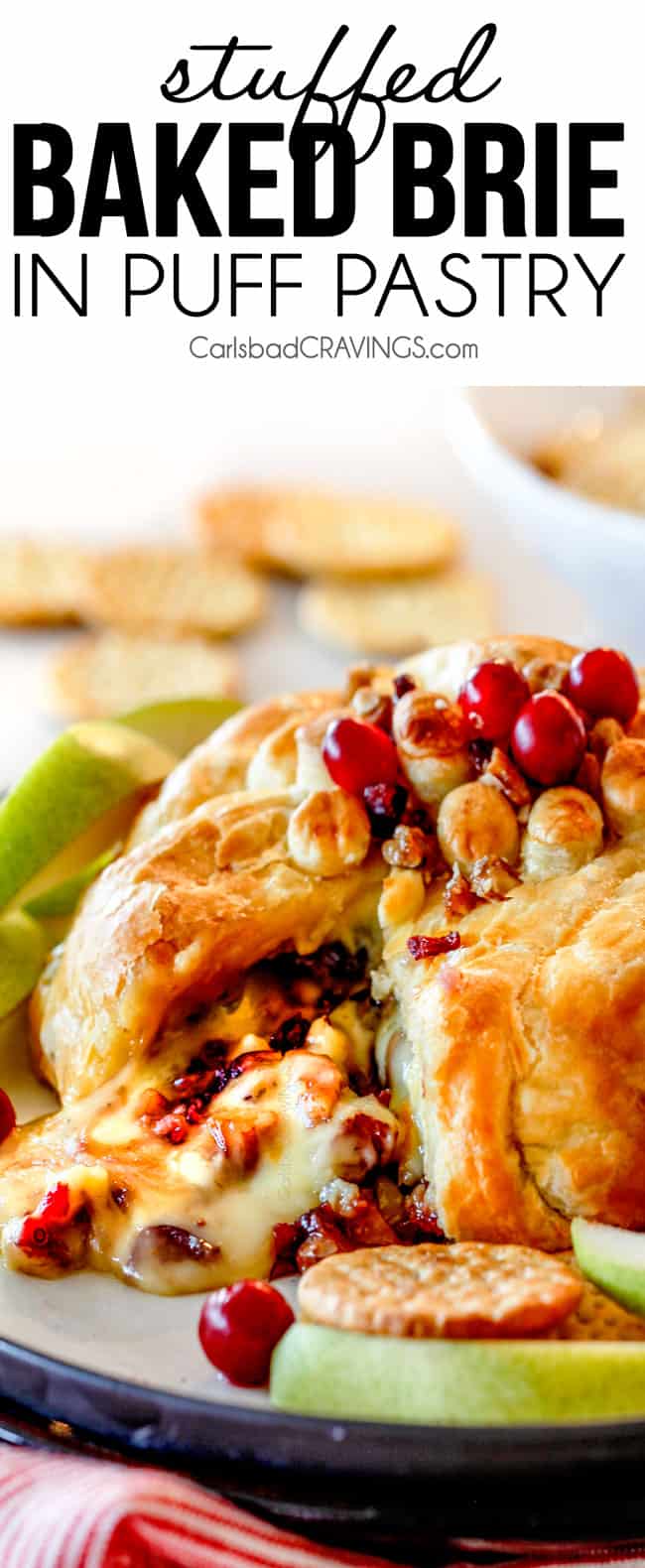 Rich and creamy Baked Brie in Puff Pastry is always a total luxuriously tasting crowd pleaser with minimal effort!ย (step by step pictures included)ย It can be prepped in advance then baked when you're ready for company!ย baked brie in puff pastry with with jam and cranberries oozing out of center