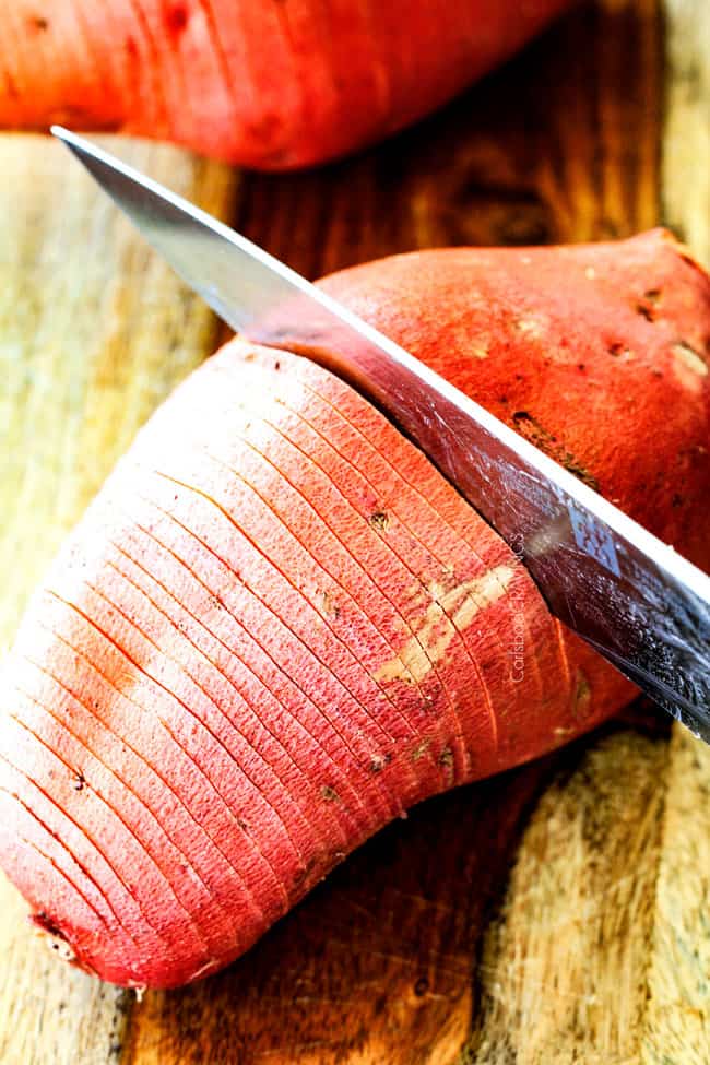 These Hasselback Sweet Potatoes are tender, melt-in-your-mouth and bursting with garlic herb, butter flavor!ย They look wonderfully gourmet for holidays and special occasions but are everyday easy!ย