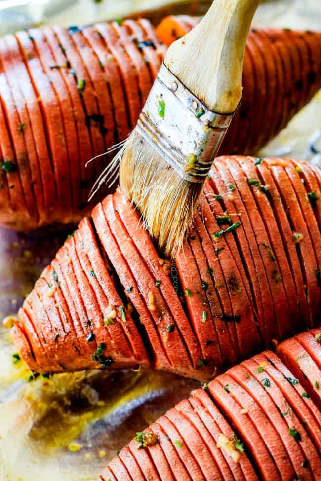 These Hasselback Sweet Potatoes are tender, melt-in-your-mouth and bursting with garlic herb, butter flavor!ย They look wonderfully gourmet for holidays and special occasions but are everyday easy!ย