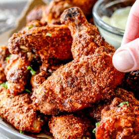 Crispy Ancho Baked Chicken Wings are tossed in the most tantalizing spice rub, baked until juicy on the inside, crispy on the outside then dunked in creamy Avocado Ranch!ย These are so ADDICTING and you can prep them all in advance without the hassle, mess and heart attach of fried wings!ย ย