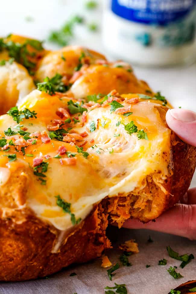 Mega flavorful Buffalo Chicken Pull Apart Bread is your favorite decadent creamy, cheesy dip baked right into a buttery biscuit ring! Crazy delicious EASY crowd pleasing appetizer perfect for parties or game day!ย ย It may look super impressive but you wonโt believe how easy it is! pulling a cheesy biscuit away from the Buffalo Chicken Pull Apart Bread
