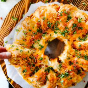 Mega flavorful Buffalo Chicken Dip Ring is your favorite decadent creamy, cheesy dip baked right into a buttery biscuit ring! Crazy delicious EASY crowd pleasing appetizer perfect for parties or game day!ย ย It may look super impressive but you wonโt believe how easy it is!