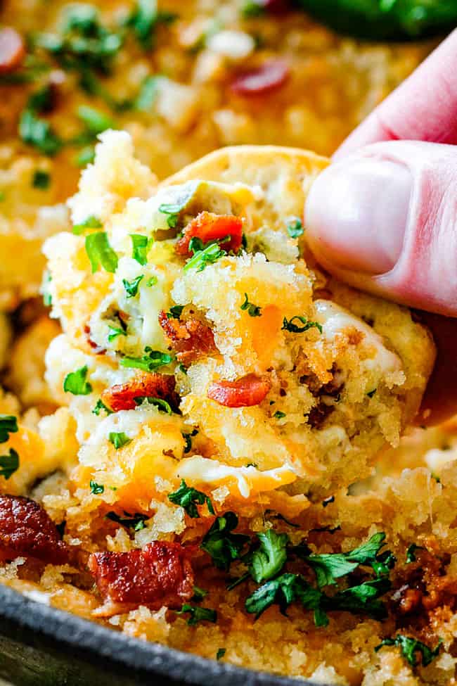 This quick and easy Jalapeno Popper Dip with Panko tastes like your favorite appetizer in EASY, warm, creamy, cheesy addicting dip form!ย It is my go-to party appetizer that everyone LOVES!!!ย showing how to make Jalapeno Popper dip by combining cream cheese, mayonnaise, sour cream, mozzarella, parmesan, cheddar and spices in a bowl