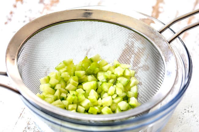 showing how to make Greek Chicken Salad by draining cucumbers
