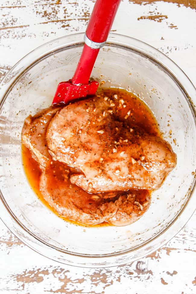 showing how to make Greek Chicken for Greek Chicken Salad by adding chicken to marinade